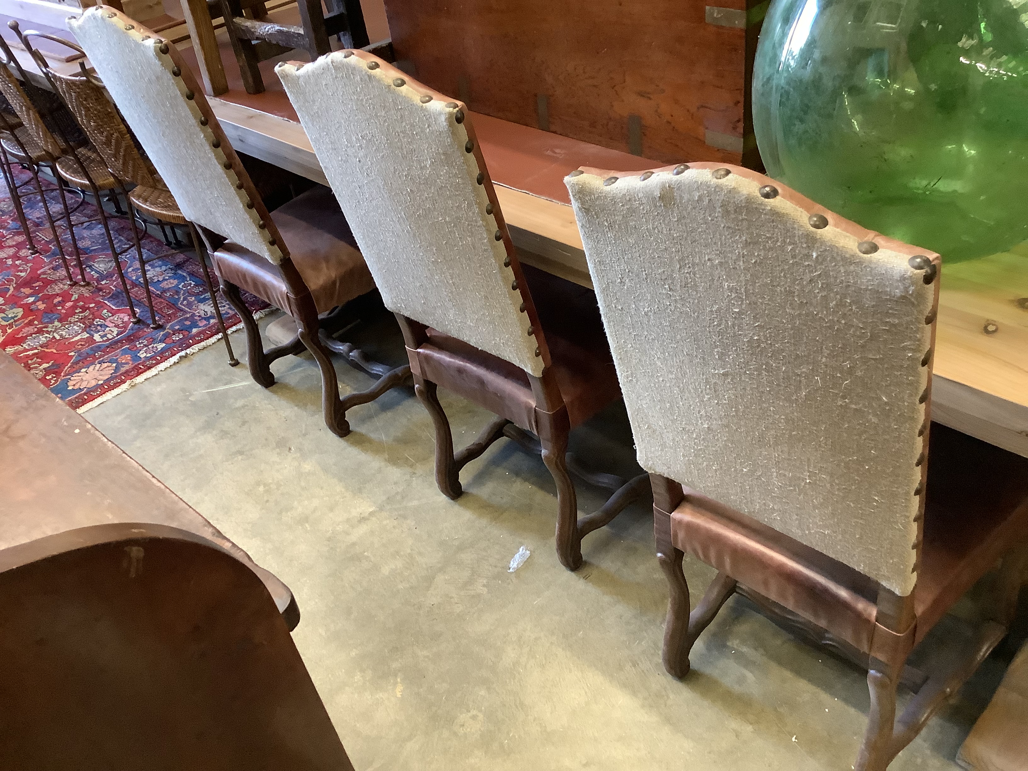A set of six French leather high back dining chairs